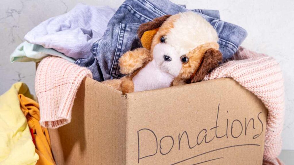 Box marked donations with clothes and toys