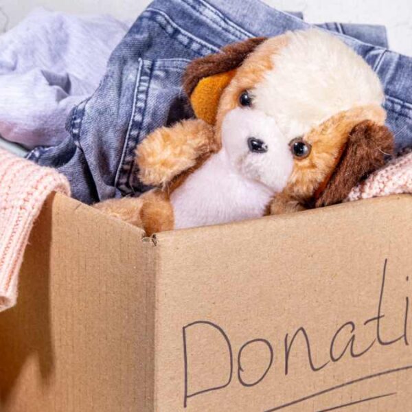 Box marked donations with clothes and toys